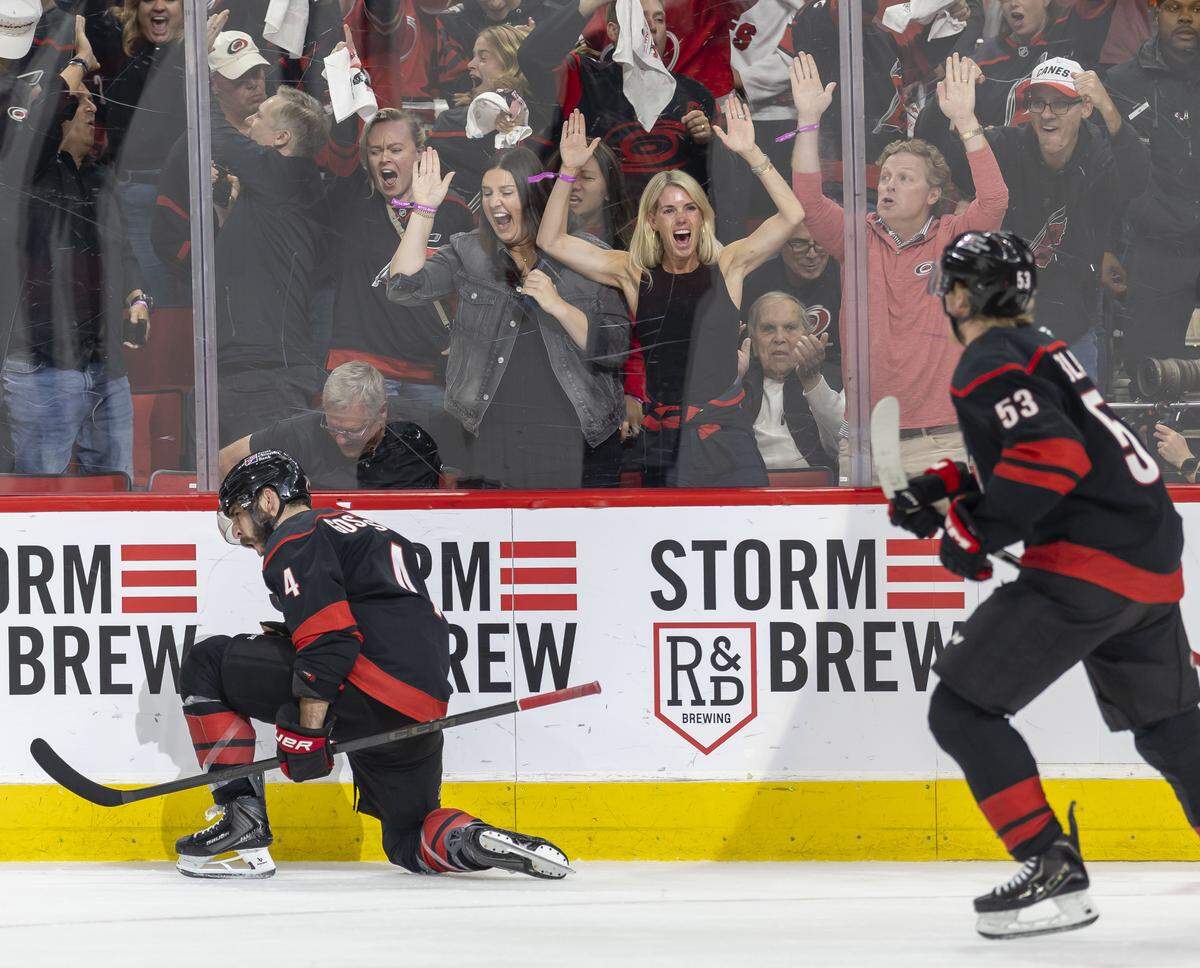Carolina Hurricanes fans celebrate after a goal by defenseman Shayne Gostisbehere (4) to tie Las Vegas 4-4 in the third period of Game 1 in the Stanley Cup Finals, on Tuesday, June 2, 2026 at Lenovo Center in Raleigh, N.C.