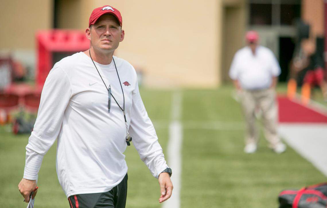 In this 2014 file photo, Arkansas defensive coordinator Robb Smith walks onto the field before a preseason NCAA college football practice at Donald W. Reynolds Razorback Stadium in Fayetteville, Ark., Saturday, Aug. 16, 2014.