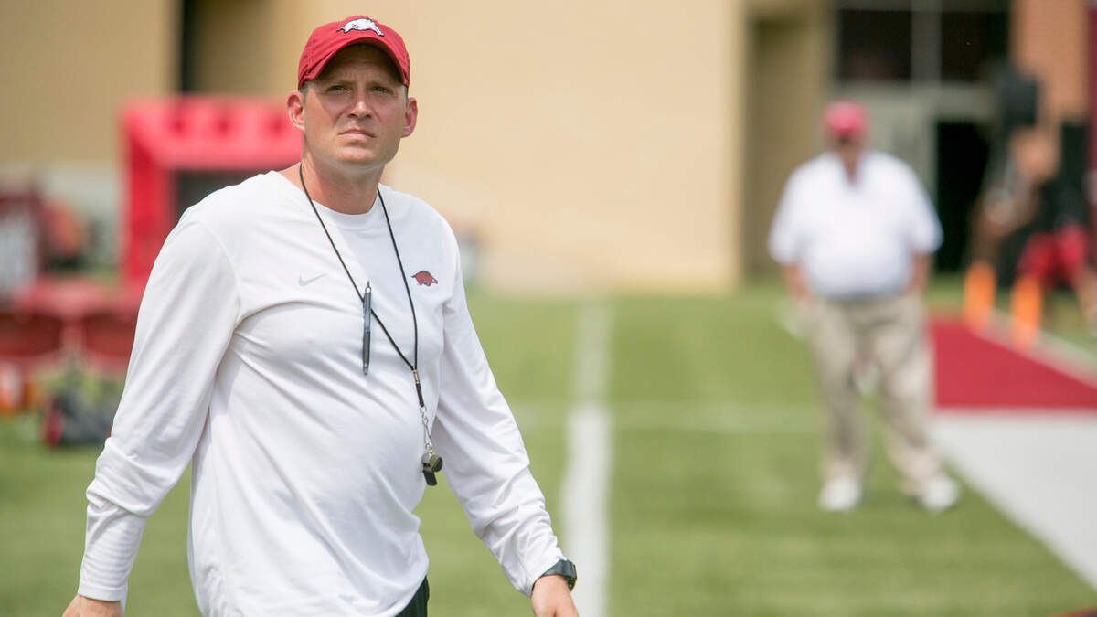 In this 2014 file photo, Arkansas defensive coordinator Robb Smith walks onto the field before a preseason NCAA college football practice at Donald W. Reynolds Razorback Stadium in Fayetteville, Ark., Saturday, Aug. 16, 2014.  