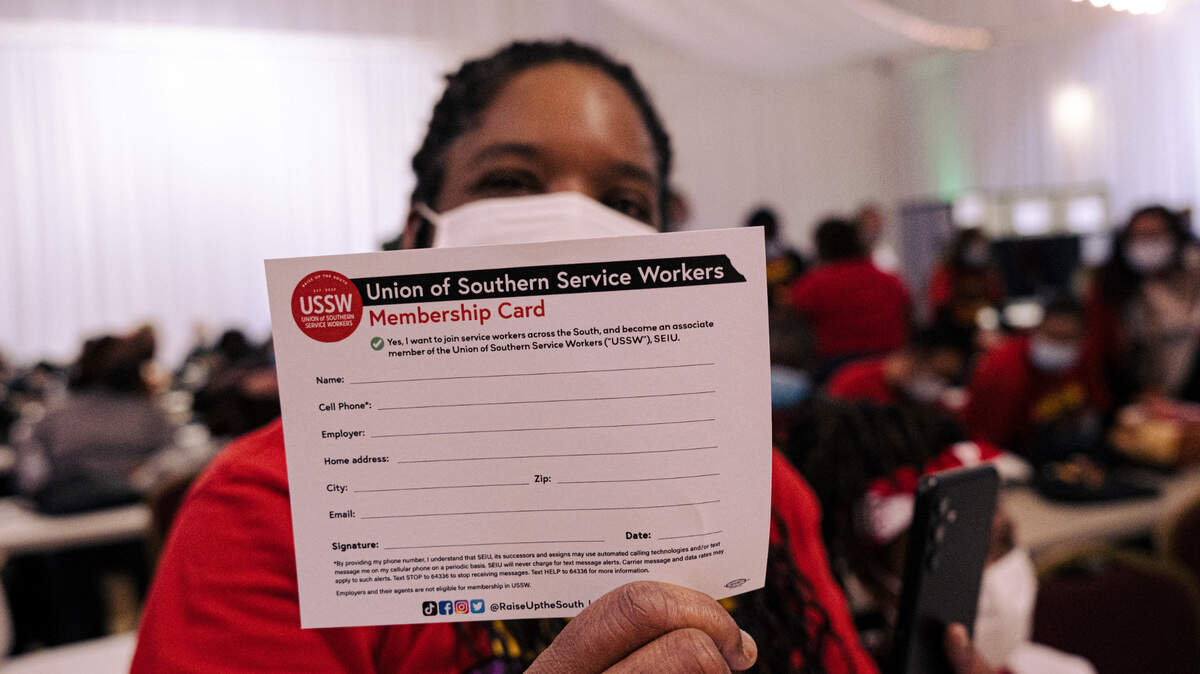 Ieisha Franceis holds up a blank USSW membership card.