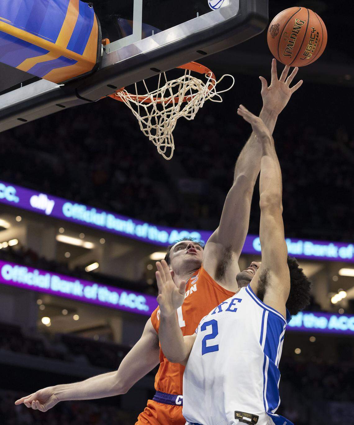 Clemson forward Nick Davidson (11) blocks a shot by Duke  guard Cayden Boozer (2) in the first half on Friday, March 13, 2026, during the semifinals of the ACC Tournament at Spectrum Center in Charlotte, N.C.