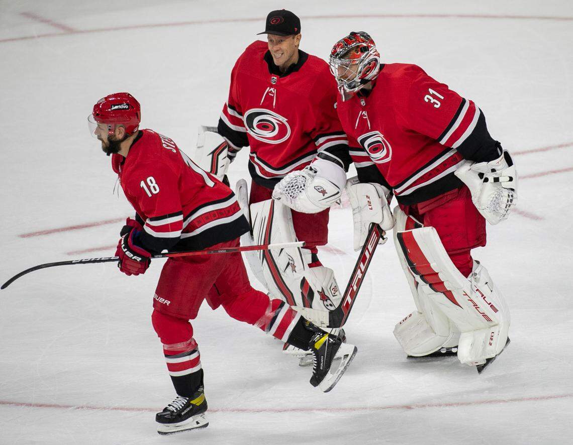 Carolina Hurricanes winning goalie Frederik Andersen (31) skates with Antii Raanta (32) as they celebrate their 6-3 victory over the New York Islanders on Thursday, October 14, 2021 at PNC Arena in Raleigh, N.C.