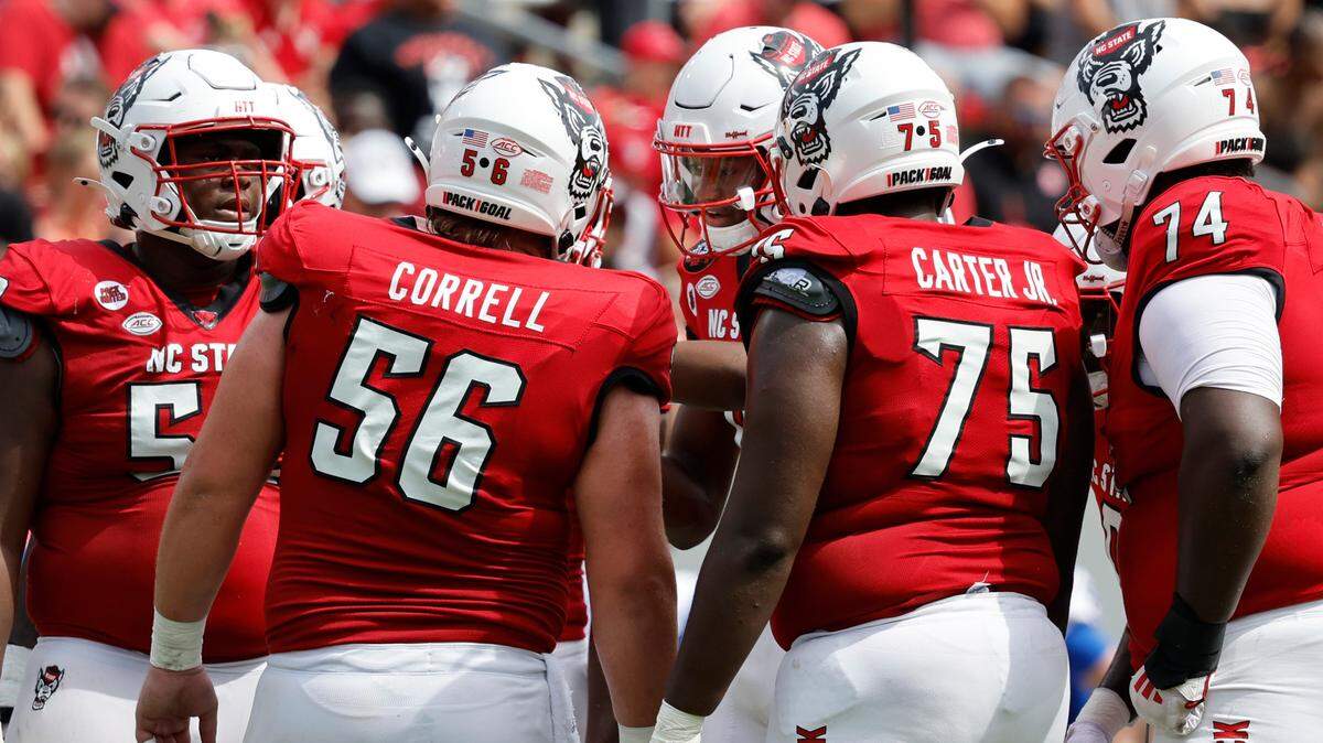 N.C. State quarterback CJ Bailey, center, huddles with the offense during the Wolfpack’s 30-20 victory over LA Tech at Carter-Finley Stadium in Raleigh, N.C., Saturday, Sept. 14, 2024.