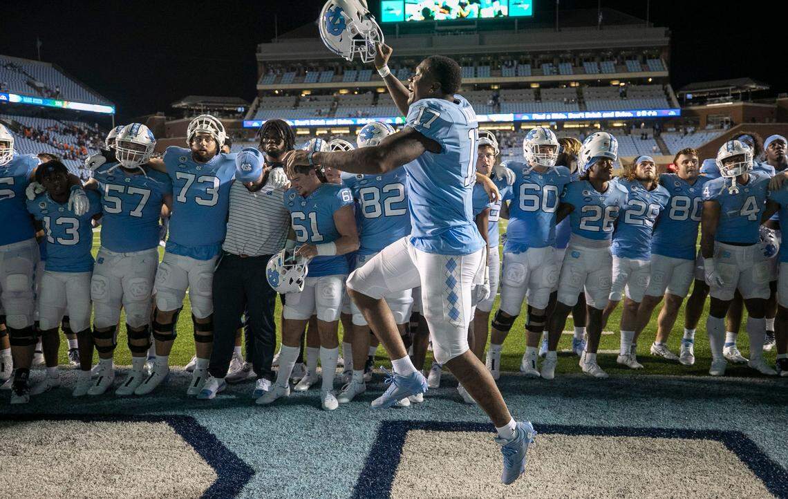 North Carolinas Chis Collins (17) celebrates the Tar Heels 56-24 victory over Florida A&M with teammate during the playing of the Alma Mater on Saturday, August 27, 2022 at Kenan Stadium in Chapel Hill, N.C.