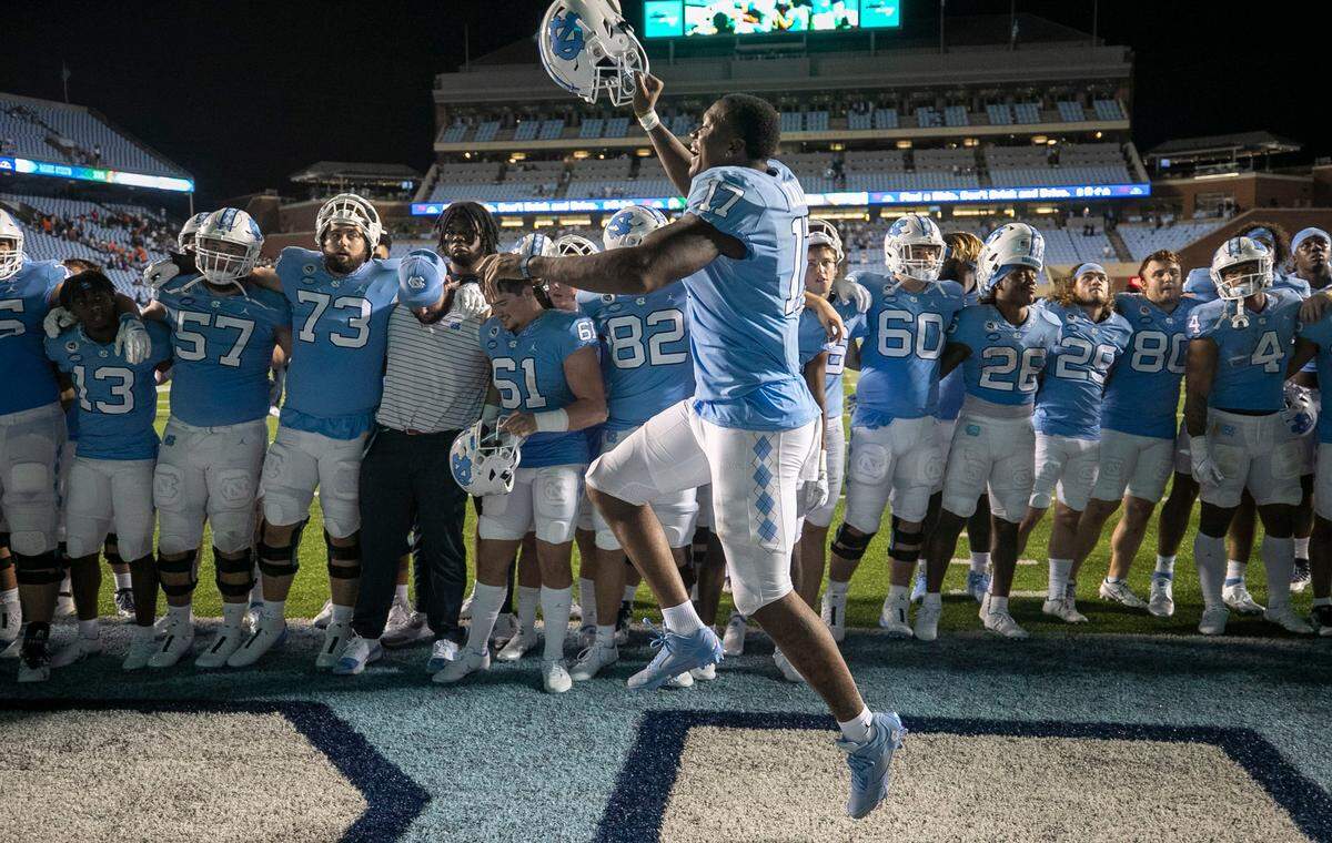 North Carolinas Chis Collins (17) celebrates the Tar Heels 56-24 victory over Florida A&M with teammate during the playing of the Alma Mater on Saturday, August 27, 2022 at Kenan Stadium in Chapel Hill, N.C.