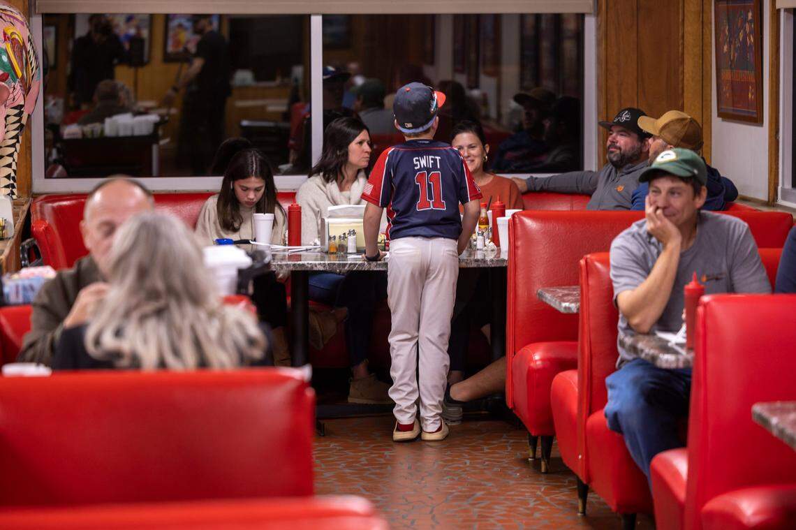 Nine-year-old Henderson Swift talks with his family after dinning with his teammates at Bar-B-Q Center on Monday, October 9, 2023 in Lexington, N.C.