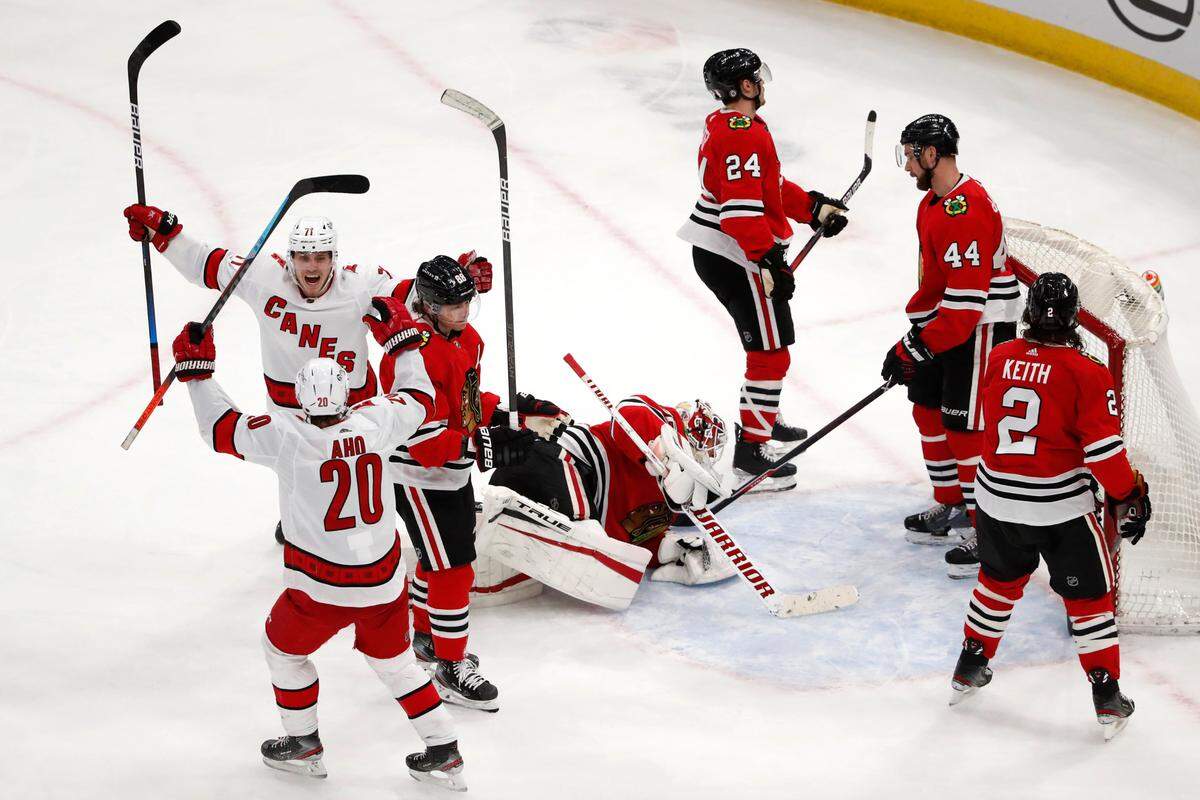 Carolina Hurricanes right wing Jesper Fast (71) celebrates his goal with Sebastian Aho (20) during the third period of an NHL hockey game against the Chicago Blackhawks on Thursday, April 1, 2021, in Chicago. The Hurricanes won 4-3. (AP Photo/Jeff Haynes)