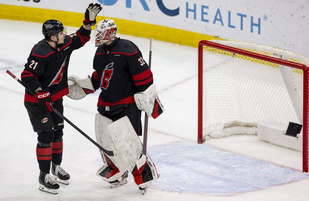 Carolina Hurricanes center Logan Stankoven (22) congratulates Carolina Hurricanes goalie Brandon Bussi (32) after defeating the Dallas Stars on Tuesday, January 6, 2026 at Lenovo Center in Raleigh, N.C.