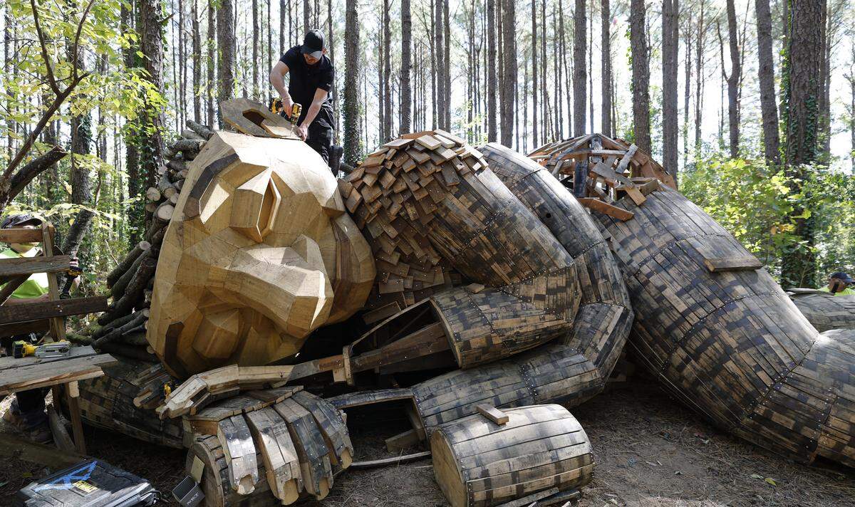 William Laufs works on mother troll at Dix Park in Raleigh, N.C. Thursday, Oct. 23, 2025. The troll is one of five Thomas Dambo trolls that are being installed at Dix. 