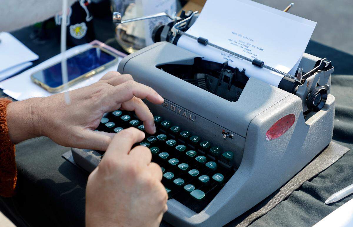 Chris Vitiello, otherwise known as the Poetry Fox, writes a poem on his 1953 Royal at the Hunt Street Art and Food Truck Market in Durham, N.C., Saturday morning, June 24, 2023.