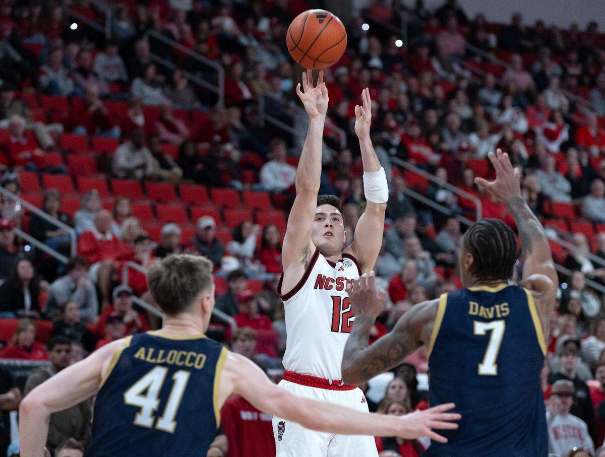 N.C. State’s Michael O’Connell puts up a shot over Notre Dame’s Matt Allocco and Tae Davis during the first half of the Wolfpack’s 66-65 win on Wednesday, Jan. 8, 2025, at Lenovo Center in Raleigh, N.C.