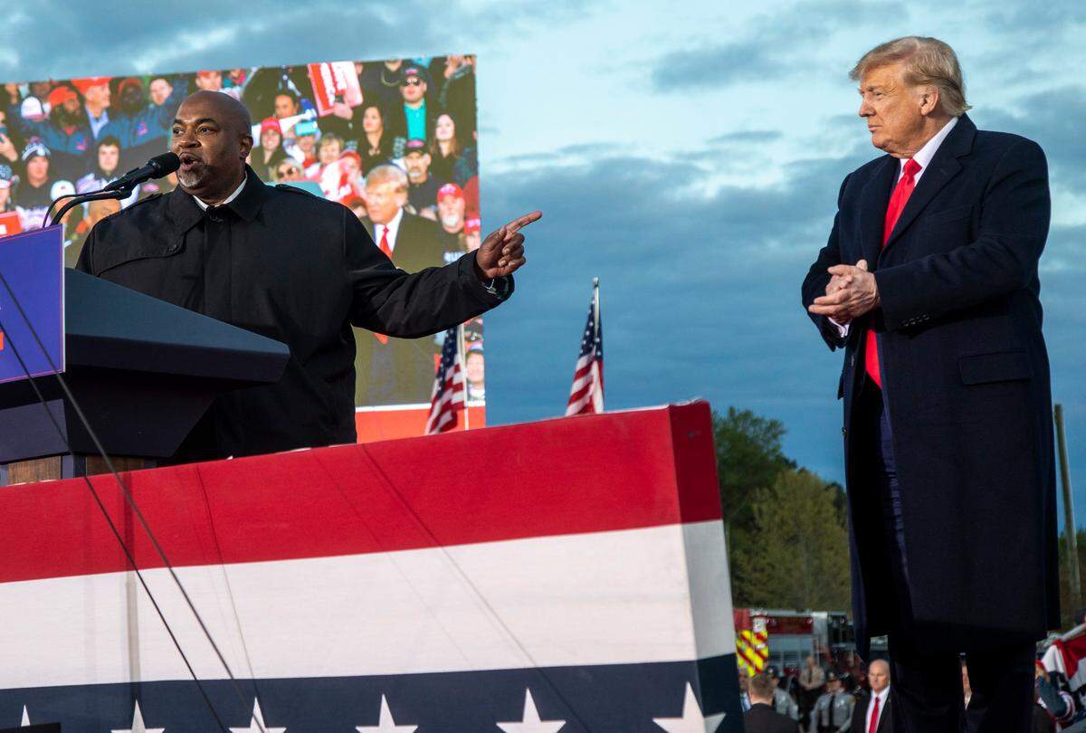Lt. Gov. Mark Robinson and former President Donald Trump share the stage during a rally in Selma Saturday, April 9, 2022.