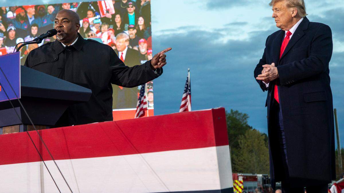 Lt. Gov. Mark Robinson and former President Donald Trump share the stage during a rally in Selma. N.C. on April 9, 2022.