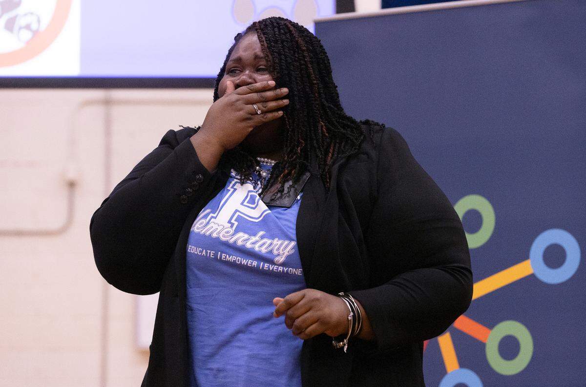 Pearsontown Elementary School Principal Asia Cunningham reacts after being awarded a Milken Educator Award on Friday, Nov. 3, 2023, in Durham, N.C.