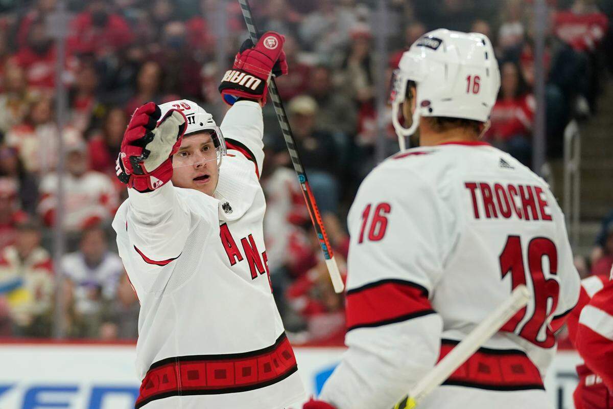 Carolina Hurricanes center Sebastian Aho (20) celebrates his goal with Vincent Trocheck (16) against the Detroit Red Wings in the first period of an NHL hockey game Tuesday, March 1, 2022, in Detroit. (AP Photo/Paul Sancya)