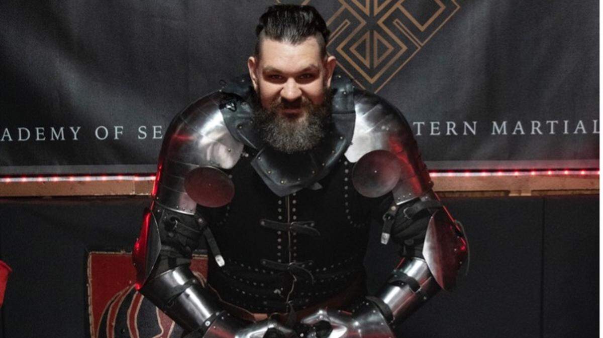 Jarred Bender, medieval combat fighter with the NC Dire Drakes, poses in his full kit of armor. The team’s members, outfitted in 80 pounds of steel armor, shields and dulled axes and swords, compete in an up-and-coming worldwide sport that combines extreme athleticism and the history of 14th- and 16th-century combat styles.