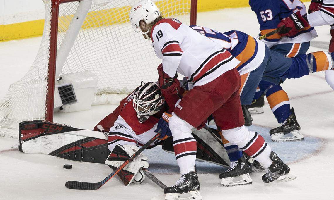 Carolina Hurricanes goalie Curtis McElhinney (35) replaces starting goalie Petr Mrazek (34) who come out the game with an injury at 13:34 in the second period during Game 2 of the second round Stanley Cup series on Sunday, April 28, 2019 a Barclays Center in Brooklyn, N.Y. McElhinney blocks a shot by New York Islanders’ Scott Mayfield (24).