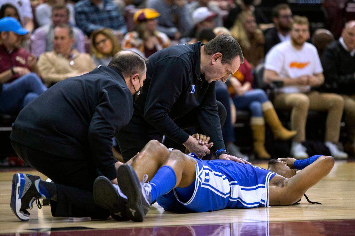 Duke coach Mike Krzyzewski holds the hand of injured guard Trevor Keels during the second half half of the tema’s NCAA college basketball game against Florida State in Tallahassee, Fla., Tuesday Jan. 18, 2022. Florida State won 79-78 in overtime. (AP Photo/Mark Wallheiser)