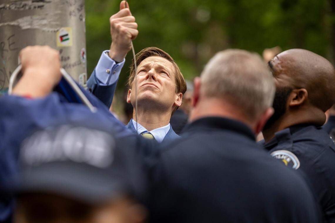 Interim Chancellor Lee Roberts and police officers work to rehang an American flag after it was brought down by demonstrators and replaced with a Palestinian flag Tuesday, April 30, 2024 at UNC-Chapel Hill. About 1000 pro-Palestinian demonstrators rallied after a “Gaza solidarity encampment” was removed by police early Tuesday morning.