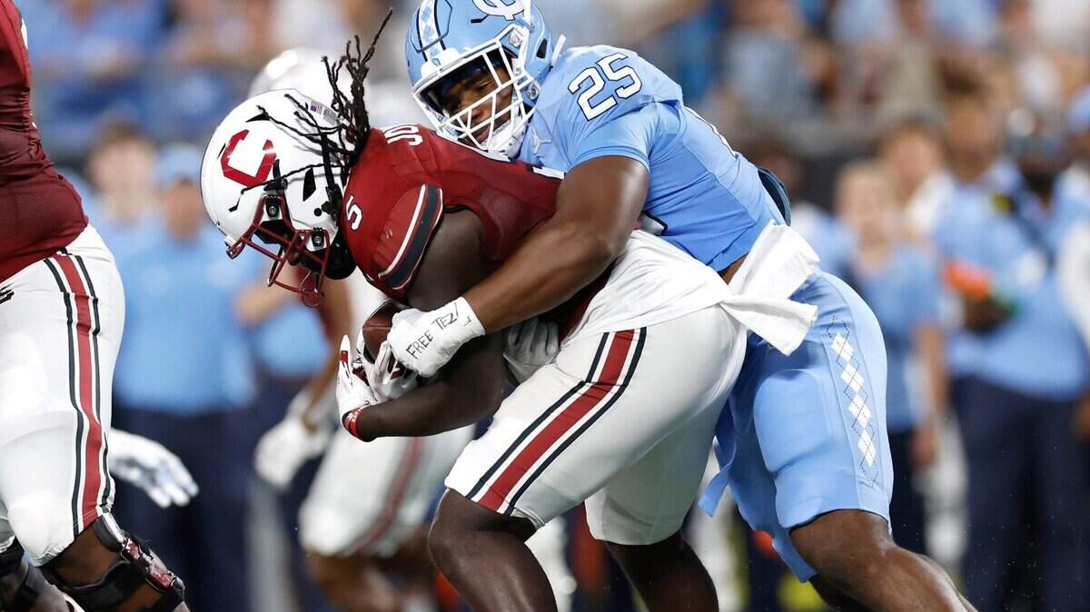 North Carolina linebacker Kaimon Rucker (25) tackles South Carolina running back Dakereon Joyner (5) during the first half of UNC’s game against South Carolina in the Duke’s Mayo Classic at Bank of America Stadium in Charlotte, N.C., Saturday, Sept. 2, 2023.