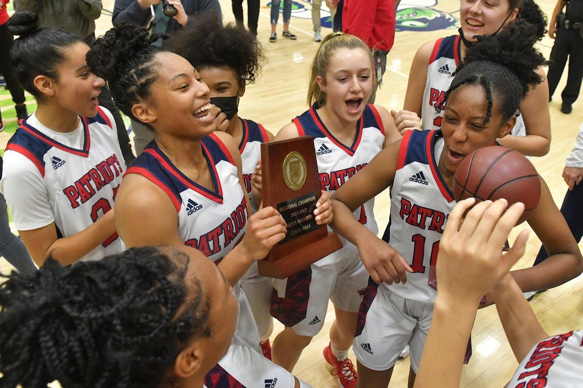 Apex Friendship’s Indya Nivar (12) and her team celebrate with the East Regional trophy after their defeat of Millbrook in the East Regional Final. The Millbrook Wildcats and the Apex Friendship Patriots met in the NCHSAA 4A Girls East Regional Finals in Cary, N.C. on March 5, 2022.