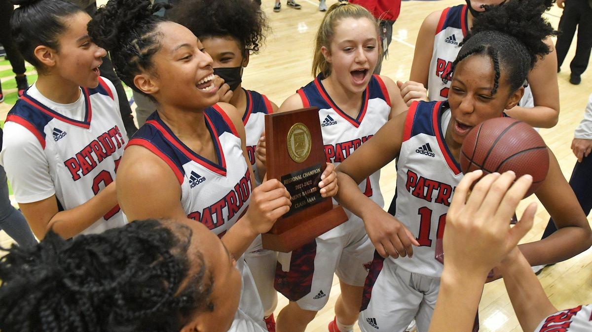 Apex Friendship’s Indya Nivar (12) and her team celebrate with the East Regional trophy after their defeat of Millbrook in the East Regional Final. The Millbrook Wildcats and the Apex Friendship Patriots met in the NCHSAA 4A Girls East Regional Finals in Cary, N.C. on March 5, 2022.