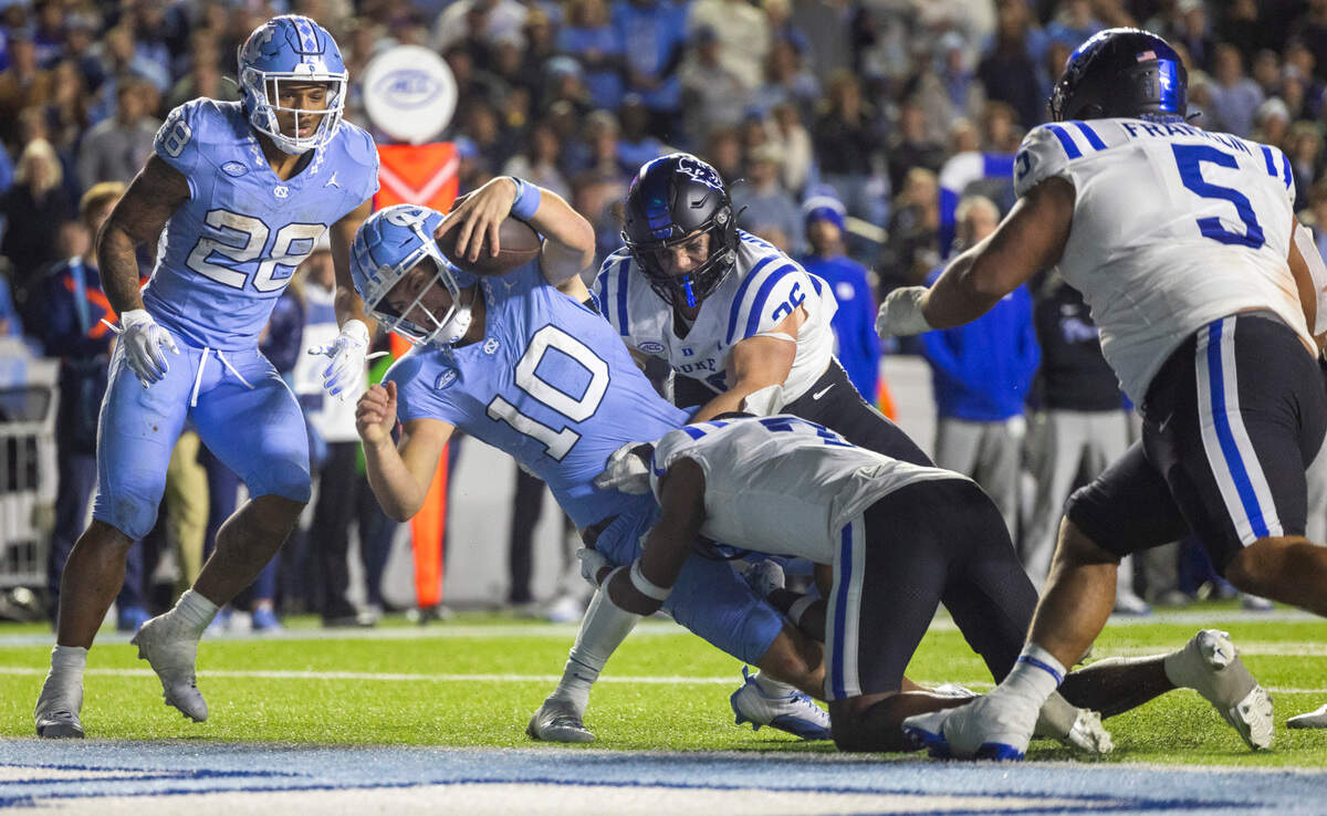 North Carolina quarterback Drake Maye (10) scores a touchdown on a five-yard run in the second over time to give the Tar Heels a 45-39 lead over Duke on Saturday, Nov. 11, 2023 at Kenan Stadium in Chapel Hill, N.C.