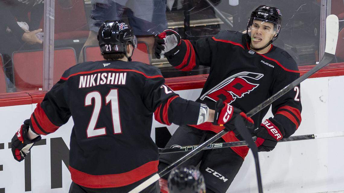Carolina Hurricanes center Logan Stankoven (22) celebrates with Alexander Nikishin (21) after scoring to take a 1-0 lead over the Ottawa Senators in the second period on Saturday, April 18, 2026 during the first round of the Stanley Cup Playoffs at Lenovo Center in Raleigh, N.C.
