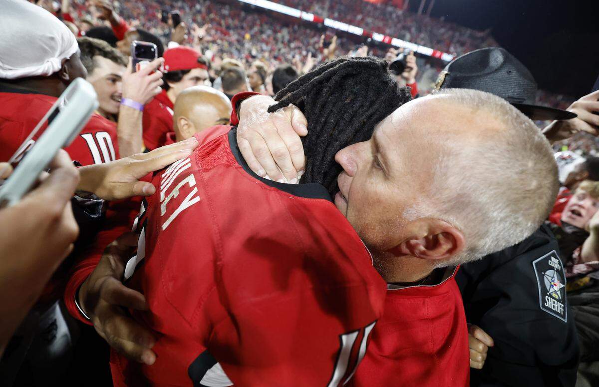 N.C. State head coach Dave Doeren hugs quarterback CJ Bailey (11) after N.C. State’s 48-36 victory over Georgia Tech at Carter-Finley Stadium in Raleigh, N.C., Saturday, Nov. 1, 2025.