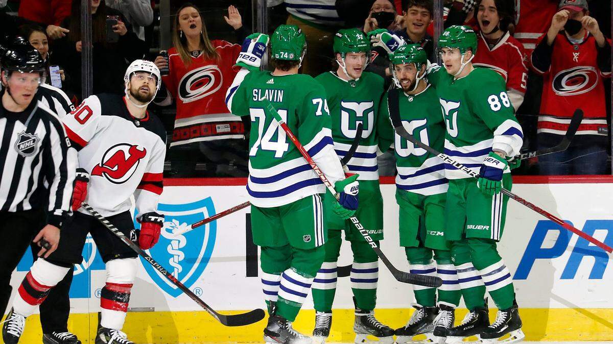 Carolina Hurricanes’ Andrei Svechnikov, third from right, celebrates his goal against the New Jersey Devils with teammates Jaccob Slavin (74), Vincent Trocheck, second right, and Martin Necas (88) during the first period of an NHL hockey game in Raleigh, N.C., Saturday, Jan. 29, 2022. (AP Photo/Karl B DeBlaker)