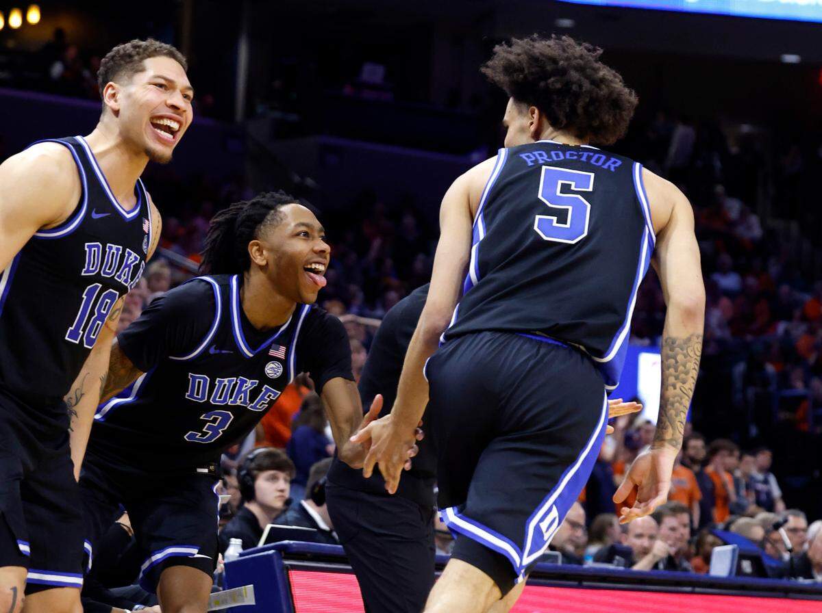 Duke’s Mason Gillis (18) and Isaiah Evans (3) celebrate after Tyrese Proctor (5) made a three-pointer during the second half of Duke’s 80-62 victory over Virginia at John Paul Jones Arena in Charlottesville, Va., Monday, Feb. 17, 2025.