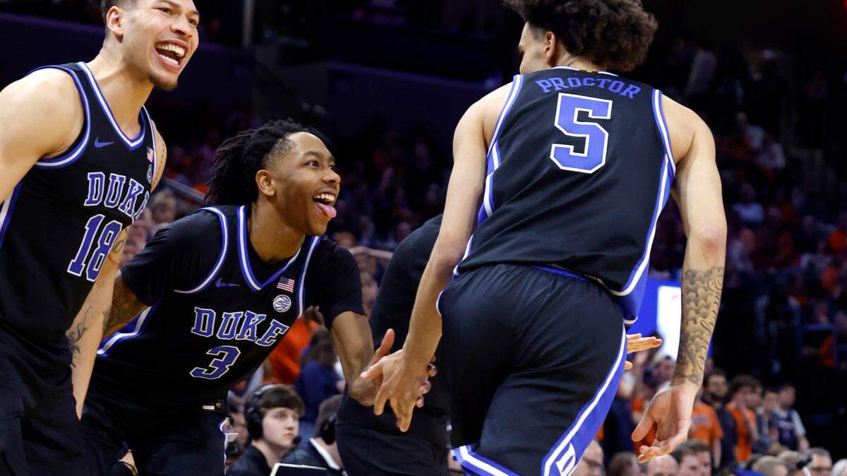 Duke’s Mason Gillis (18) and Isaiah Evans (3) celebrate after Tyrese Proctor (5) made a three-pointer during the second half of Duke’s 80-62 victory over Virginia at John Paul Jones Arena in Charlottesville, Va., Monday, Feb. 17, 2025.