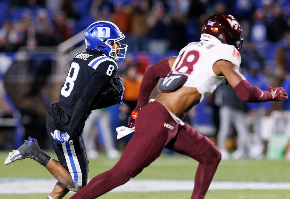Duke’s Jordan Moore runs the ball past Virginia Tech’s Mose Phillips III during the first half of the Blue Devils’ game on Saturday, Nov. 23, 2024, at Wallace Wade Stadium in Durham, N.C.