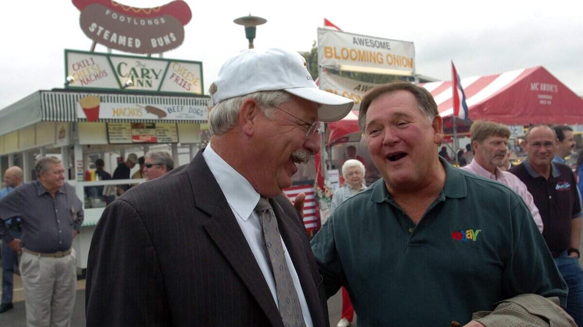 Commissioner of Agriculture Steve Troxler, left, has friendly chat with former NC Attorney general Rufus Edmisten at the State Fair. in 2005. (N&O file photo)