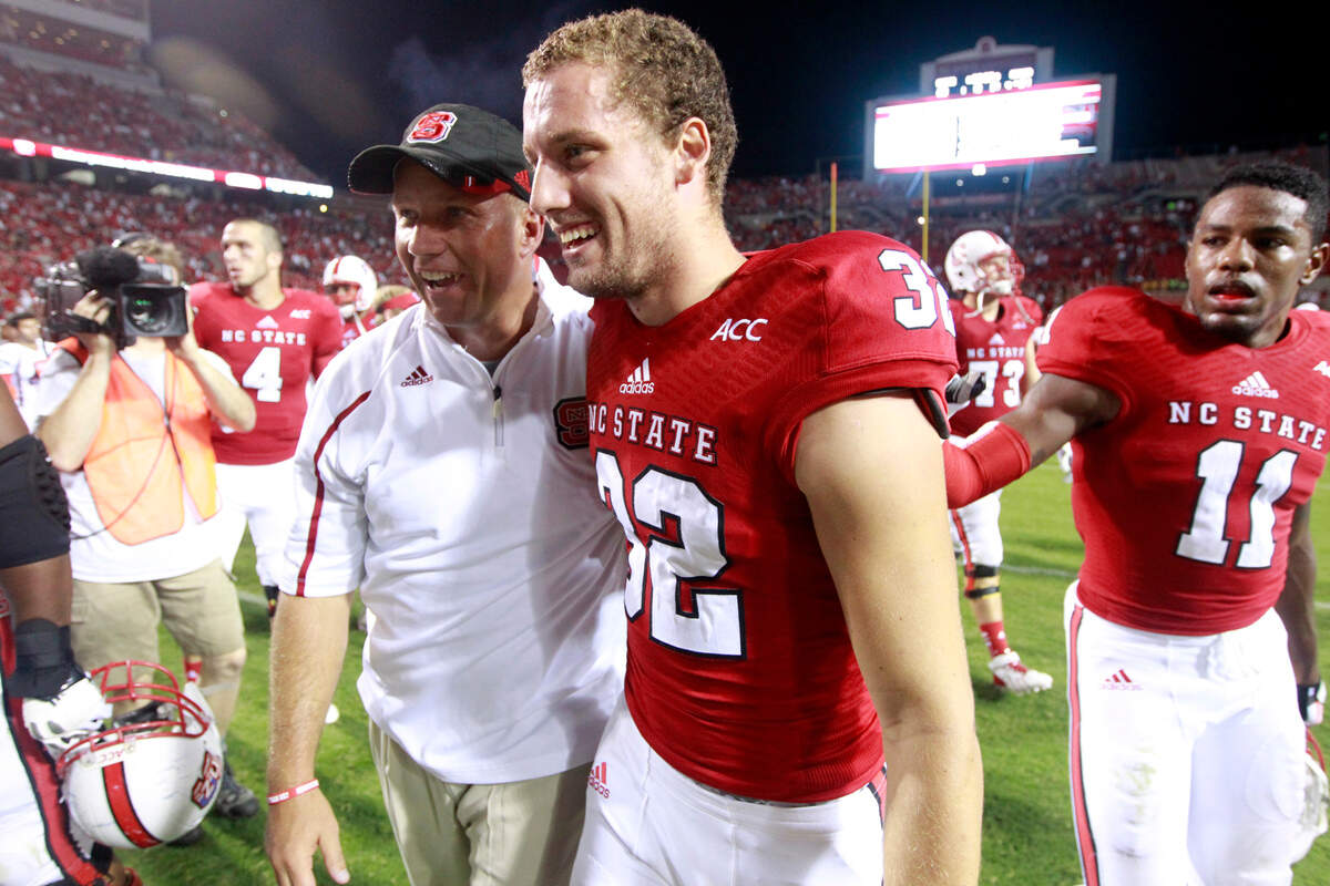 N.C. State’s head coach Dave Doeren celebrates with kicker Niklas Sade (32) after N.C. State’s 23-21 victory over Richmond Saturday, September 7, 2013, at Carter-Finley Stadium in Raleigh, N.C.