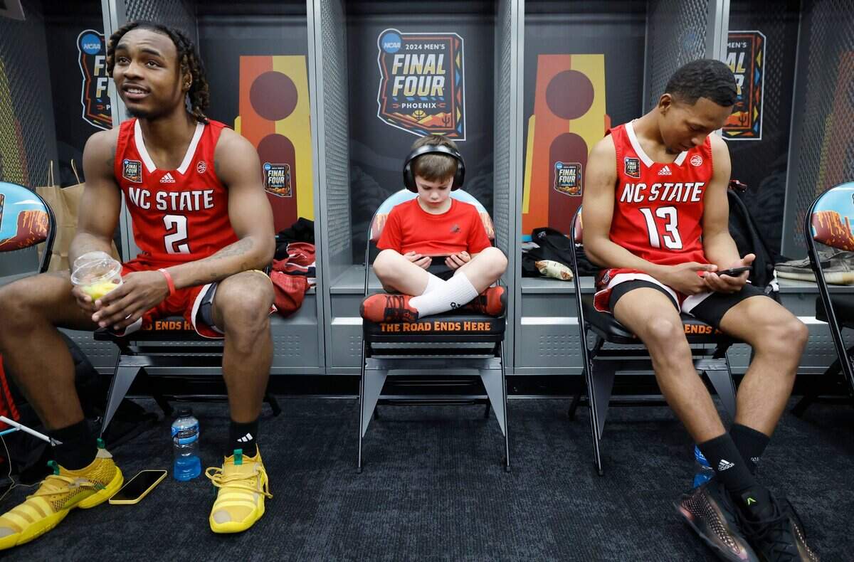 Drew Murphy, center, son of strength and conditioning coach Pat Murphy, along with N.C. State’s Kam Woods (2) and KJ Keatts (13) hang out during an availability in the N.C. State locker room at State Farm Stadium in Glendale, Ariz. Thursday, April 4, 2024. The Wolfpack will face Purdue in the Final Four on Saturday.