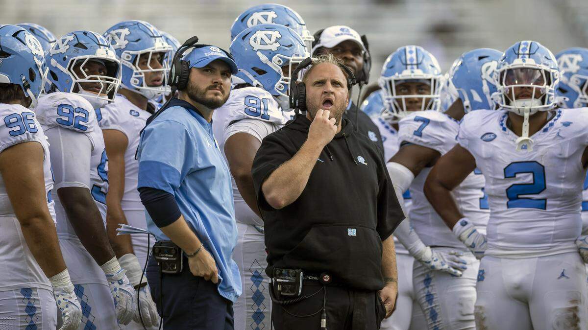 Down 13-0 in the second quarter to the University of Central Florida, North Carolina defensive coordinator Steve Belichick studies a replay on the scoreboard during a time-out on Saturday, September 20, 2025 at Acrisure Bounce House Stadium in Orlando, Fla.