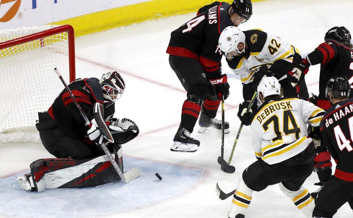 Carolina’s Curtis McElhinney (35) makes the stop as Boston’s David Backes (42) tries to score during the first period of the Carolina Hurricanes’ game against the Boston Bruins in game three of the Eastern Conference finals at PNC Arena in Raleigh, N.C. Tuesday, May 14, 2019.