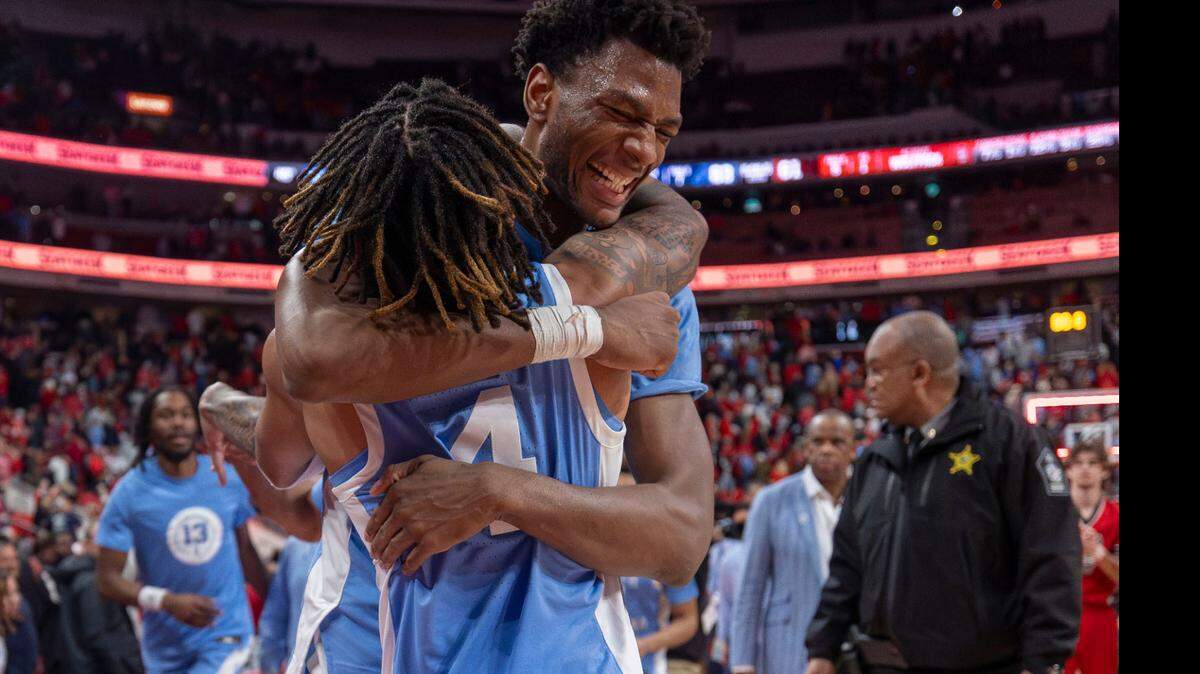North Carolina guard R.J. Davis (4) embraces teammate Jalen Washington (13), after his blocked shot secured the Tar Heels’ 63-61 victory over N.C. State on Saturday, January 11, 2025 at Lenovo Center in Raleigh, N.C.