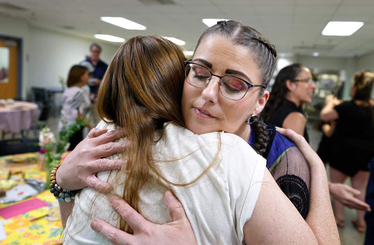 Lela Brantley hugs another participant after a Mother’s Day tea at Healing Transitions in Raleigh, N.C., Saturday, May 10, 2025. Healing Transitions is a place for recovery of all addictions. The tea was organized by Brantley and participant Jill Hurt, both of whom are recovering from alcohol addiction.