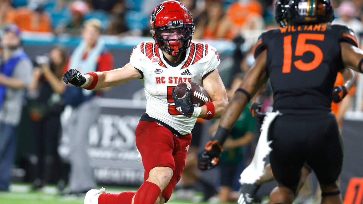 N.C. State wide receiver Thayer Thomas (5) runs past the Miami defense including safety Avantae Williams (15) to score on a 27-yard touchdown reception during the first half of N.C. State’s game against Miami at Hard Rock Stadium in Miami Gardens, Fla. Saturday, Oct. 23, 2021.