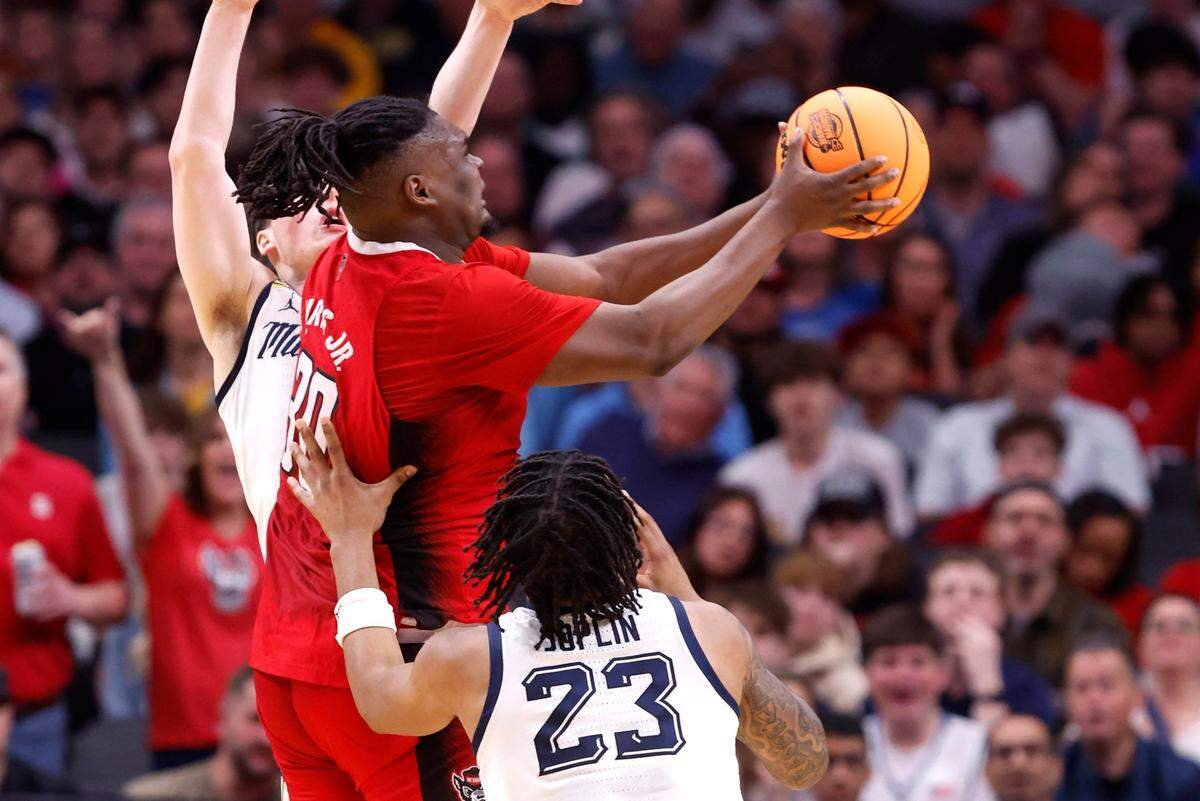 N.C. State’s DJ Burns Jr. (30) drives to the basket past Marquette’s Tyler Kolek (11) and David Joplin (23) during the first half of N.C. State’s game against Marquette in their NCAA Tournament Sweet 16 game at the American Airlines Center in Dallas, Texas, Friday, March 29, 2024.