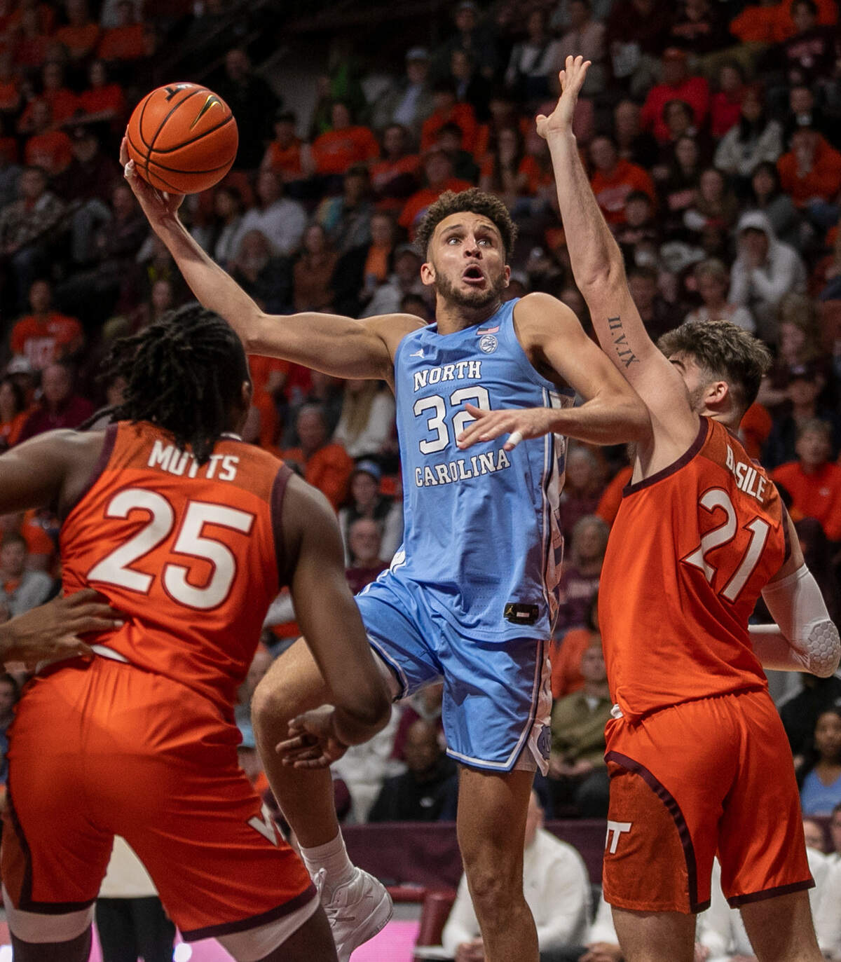 North Carolina’s Pete Nance (32) puts up a shot against Virginia Tech’s Grant Basile (21) during the second half on Sunday, December 4, 2022 at Cassell Coliseum in Blacksburg, Va. Nance scored 18 points in the Tar Heels’ loss.
