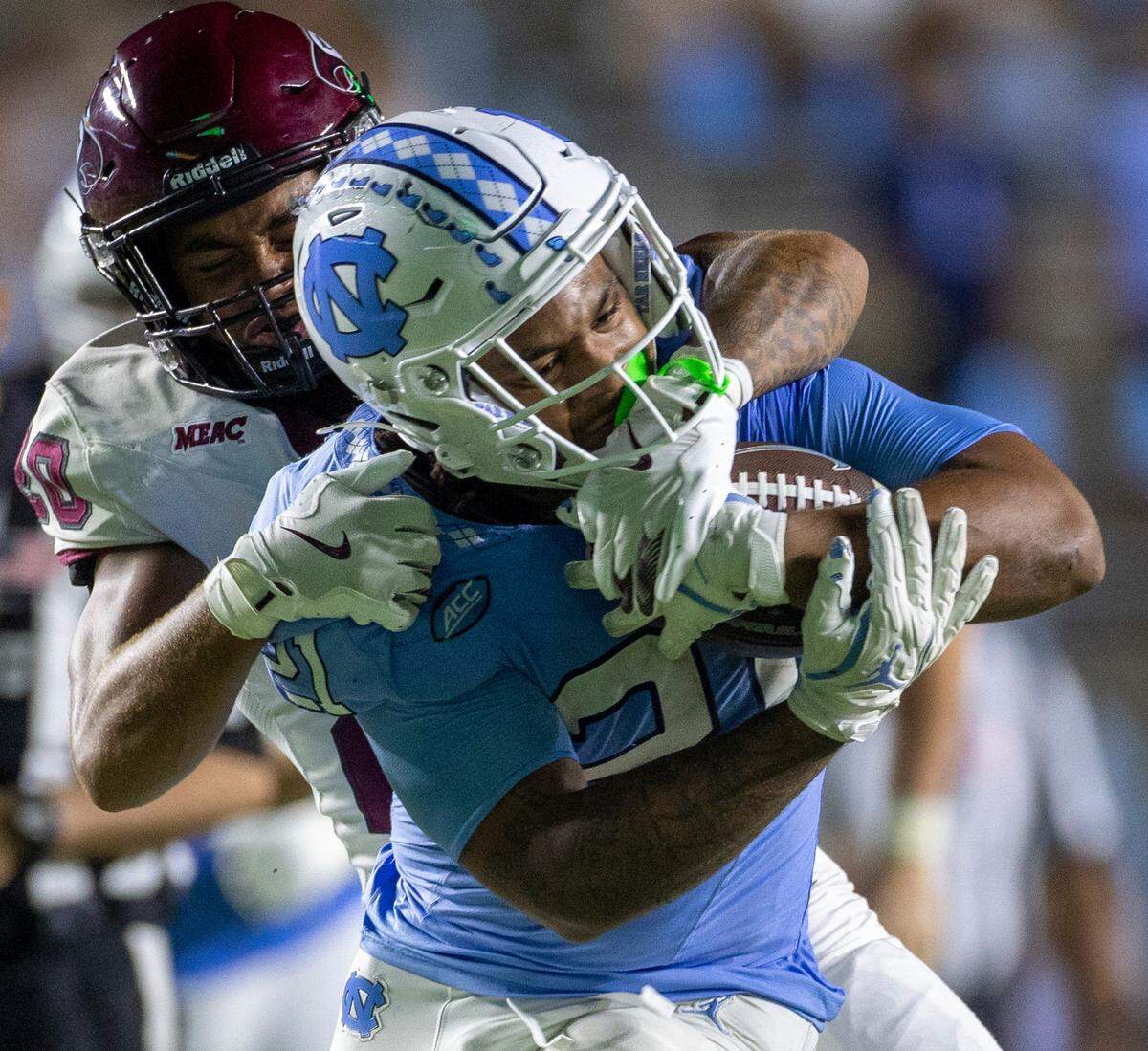 North Carolina Central defensive back Eric Adams (20) works to stop North Carolina running back Davion Gause (21) after a 21-yard gain in the fourth quarter on Saturday, September 14, 2024 at Kenan Stadium in Chapel Hill, N.C.