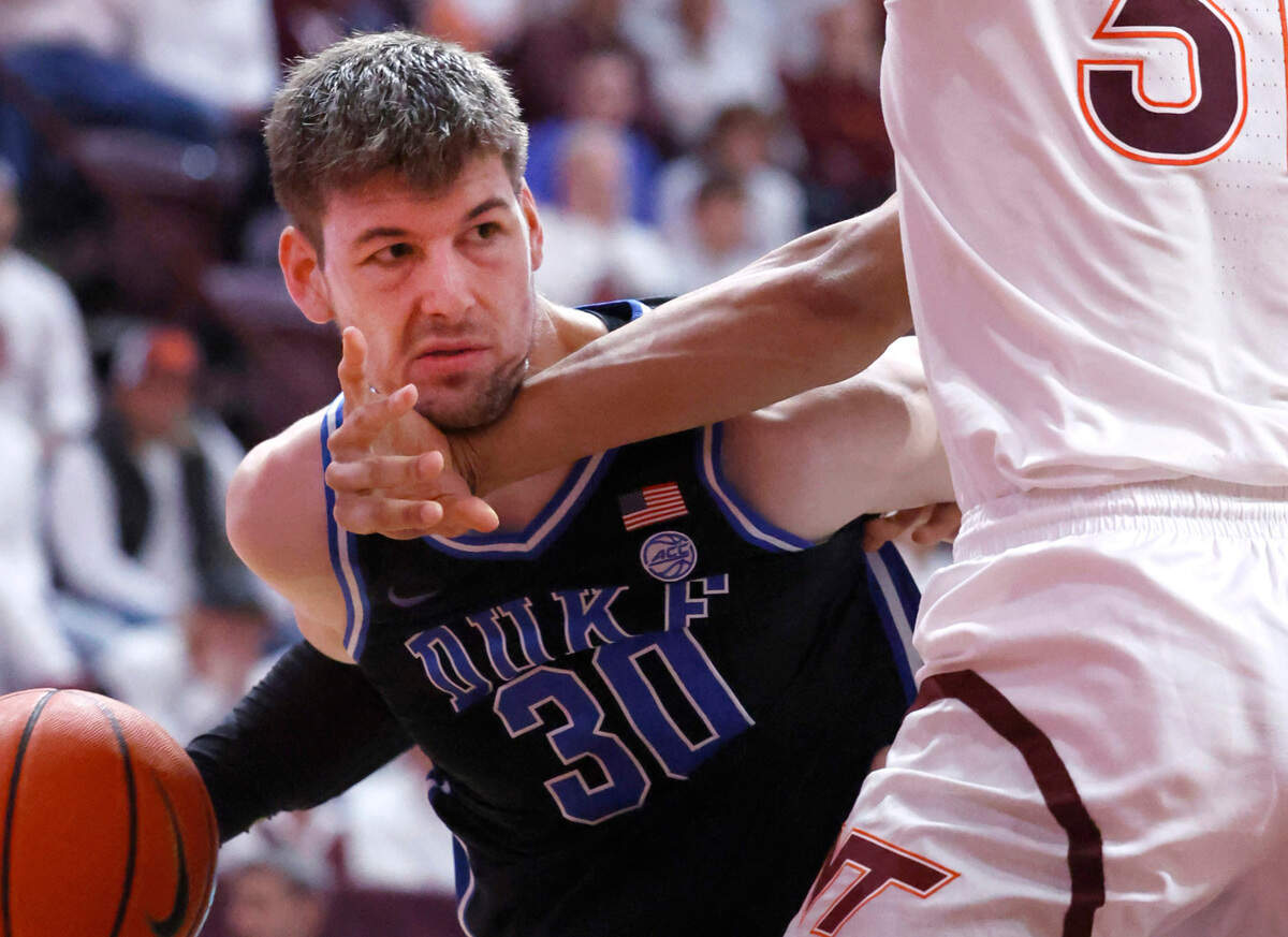 Duke’s Kyle Filipowski (30) works around Virginia Tech’s Lynn Kidd (15) during the second half of Duke’s 77-67 victory over Virginia Tech at Cassell Coliseum in Blacksburg, Va., Monday, Jan. 29, 2024.