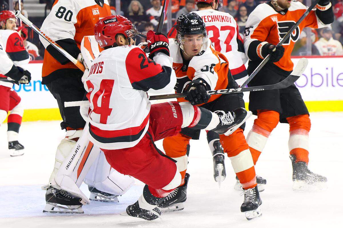 Denver Barkey (52) of the Philadelphia Flyers collides with Seth Jarvis of the Carolina Hurricanes during the first period of Game 4 of the teams’ second-round Stanley Cup playoff game at Xfinity Mobile Arena on May 9, 2026 in Philadelphia, Pennsylvania.