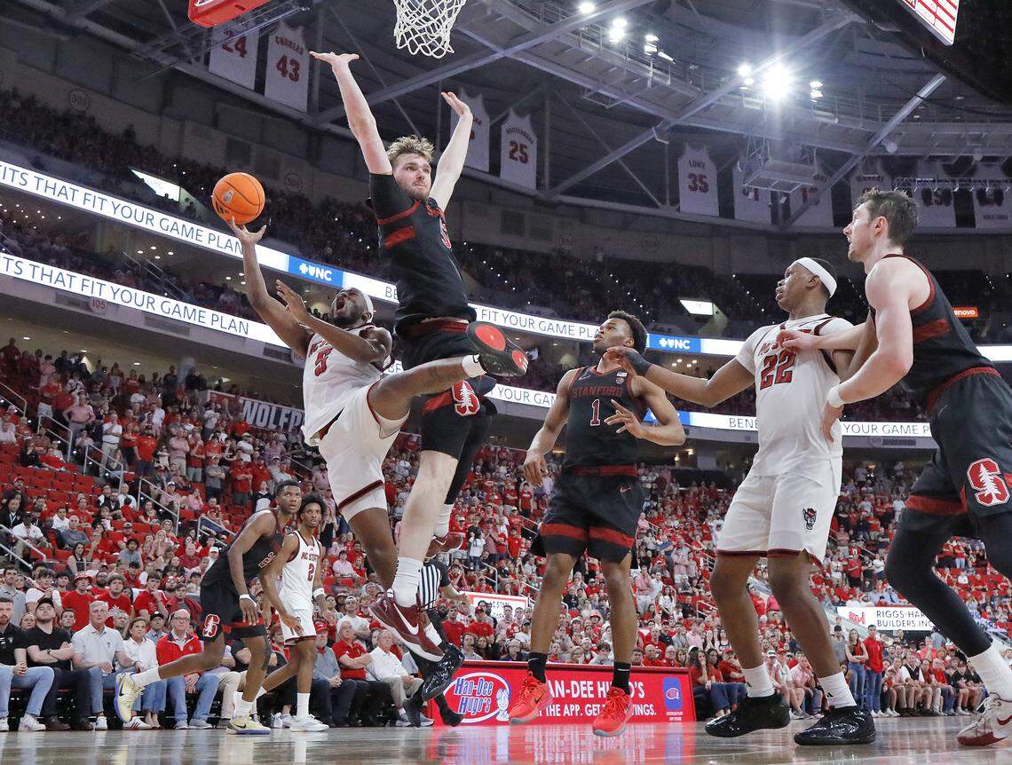 N.C. State's Tre Holloman drives to the basket against Stanford's Aidan Cammann during the second half of the Wolfpack’s 85-84 loss on Saturday, March 7, 2026, at Lenovo Center in Raleigh, N.C.