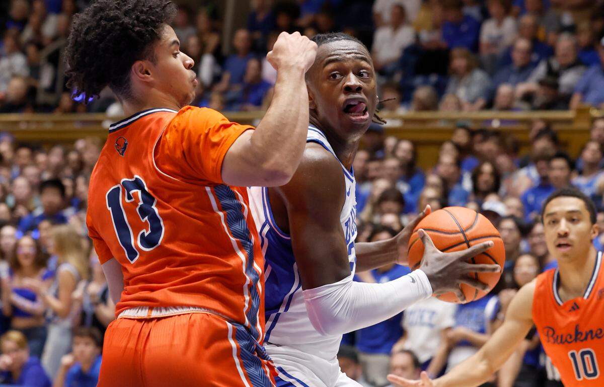 Duke’s Mark Mitchell (25) looks for room as Bucknell’s Josh Bascoe (13) defends during the first half of Duke’s game against Bucknell at Cameron Indoor Stadium in Durham, N.C., Friday, Nov. 17, 2023.