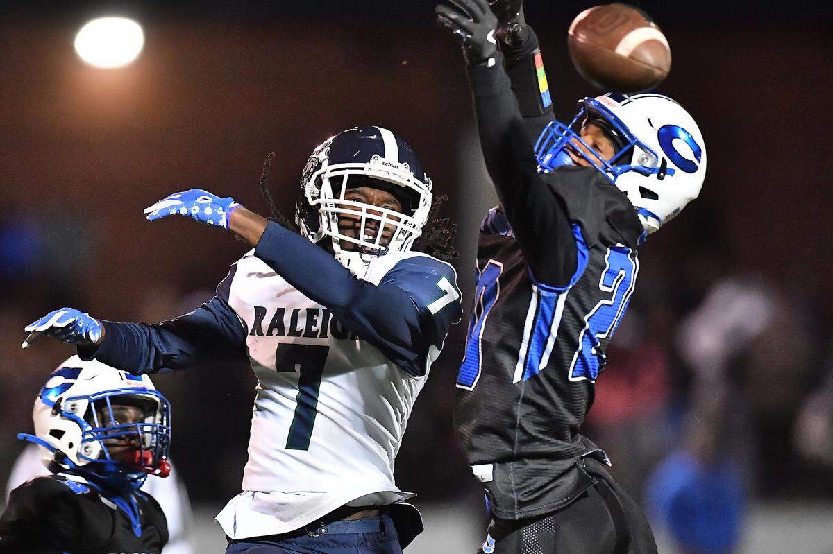 Clayton defensive back Malachi Burt (20) defends the pass to Southeast Raleigh wide receiver Tyrus Whyte (7) during the first half. The Clayton Comets and the Southeast Raleigh Bulldogs met in the fourth round of the NCHSAA 7A Playoffs in Clayton, N.C. on November 28, 2025.