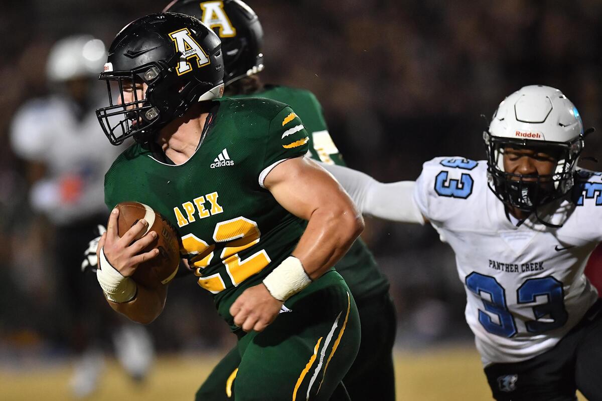 Apex’s Ian Bright (22) runs for yardage ahead of Panther Creek’s Braylon Lamar (33) during the first half. The Apex Cougars and the Panther Creek Catamounts met in a NCHSAA 4A 1st round football playoff game in Apex, NC on November 4, 2022.